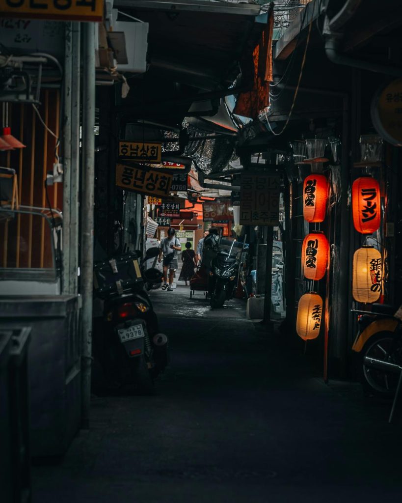 people in dark narrow alley