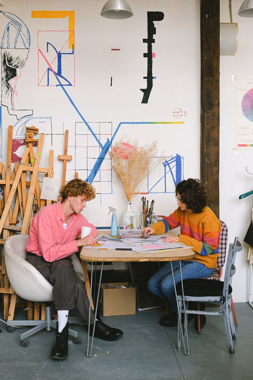 creative painters drawing at table