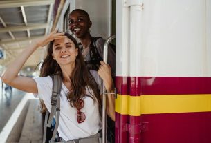 women standing on the train door