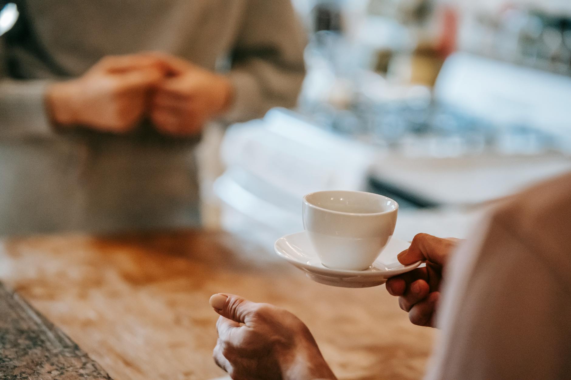 anonymous couple drinking coffee in kitchen