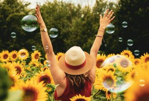 woman surrounded by sunflowers
